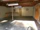 Spacious garage featuring exposed beams, concrete flooring, and wooden work benches at 44716 Gold Branch Rd, Richfield, NC 28137
