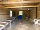 Unfinished garage with wood walls, exposed beams, a few windows, and building materials at 44716 Gold Branch Rd, Richfield, NC 28137