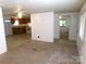 Open-concept living area flowing into the kitchen, offering a flexible layout with neutral tones at 44716 Gold Branch Rd, Richfield, NC 28137