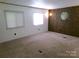 Spacious living room with plush carpeting, ample natural light, and retro octagonal mirror feature at 44716 Gold Branch Rd, Richfield, NC 28137