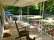 Relaxing covered porch adorned with rocking chairs and colorful flowers, creating a welcoming entrance at 44716 Gold Branch Rd, Richfield, NC 28137