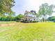 Charming two-story home with a spacious front porch surrounded by a lush green lawn at 4815 Nc 109 Hwy, Wadesboro, NC 28170