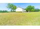 Side view of a white garage with three bays and green trim on a green lawn at 4815 Nc 109 Hwy, Wadesboro, NC 28170