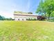Side view of a white garage with three bays and green trim on a green lawn at 4815 Nc 109 Hwy, Wadesboro, NC 28170