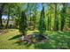 Lush backyard with a charming water feature surrounded by trees at 539 30Th Nw Ave, Hickory, NC 28601
