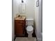 Half bathroom featuring a wood vanity with tan top and black tile flooring at 539 30Th Nw Ave, Hickory, NC 28601