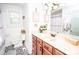 Bathroom featuring decorative floor tiles, a wood vanity, and bright decor for a spa-like retreat at 539 30Th Nw Ave, Hickory, NC 28601