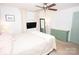 Cozy bedroom featuring a ceiling fan, mounted TV, and decorative dresser at 539 30Th Nw Ave, Hickory, NC 28601