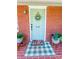 Close up of a charming front door with a wreath, welcome mat, and potted plants at 539 30Th Nw Ave, Hickory, NC 28601