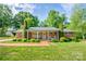 Charming brick home featuring a well-manicured lawn, tidy landscaping and a welcoming front porch at 539 30Th Nw Ave, Hickory, NC 28601