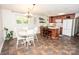 Cozy eat-in kitchen with a tile floor, wooden cabinets, a white refrigerator, and a dining area at 539 30Th Nw Ave, Hickory, NC 28601