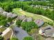 Beautiful aerial view of a neighborhood nestled amongst lush green trees adjacent to a golf course at 54053 Flycatchers Ct, Fort Mill, SC 29707