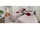 Shared bedroom with two beds featuring pink patterned bedding and wooden headboards at 54053 Flycatchers Ct, Fort Mill, SC 29707