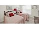 Bedroom featuring two beds with pink bedding, side table with lamp, and a window at 54053 Flycatchers Ct, Fort Mill, SC 29707