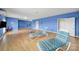 Bright bonus room with hardwood floors, workout equipment, lounge chairs, and a nautical theme at 54053 Flycatchers Ct, Fort Mill, SC 29707