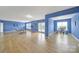 Open floor plan bonus room with hardwood floors, workout equipment, a desk, and natural light at 54053 Flycatchers Ct, Fort Mill, SC 29707