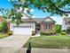 Beautiful home exterior featuring a well-maintained lawn, stone accents, and a two-car garage at 54053 Flycatchers Ct, Fort Mill, SC 29707