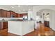 A view of kitchen with granite countertops and stainless steel appliances open to the foyer at 54053 Flycatchers Ct, Fort Mill, SC 29707