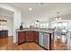 Eat-in kitchen with granite countertops, hardwood floors, stainless steel appliances and access to the living room at 54053 Flycatchers Ct, Fort Mill, SC 29707