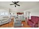 Open-concept living room flows into the dining area and kitchen, featuring hardwood floors and plenty of seating at 54053 Flycatchers Ct, Fort Mill, SC 29707