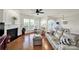 Inviting living room with hardwood floors, a cozy fireplace, and large windows offering scenic views at 54053 Flycatchers Ct, Fort Mill, SC 29707