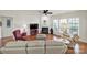 Bright living room featuring a fireplace, hardwood floors, and multiple windows providing natural light at 54053 Flycatchers Ct, Fort Mill, SC 29707