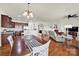 An open floor plan features kitchen, dining, and living area with hardwood floors and natural light at 54053 Flycatchers Ct, Fort Mill, SC 29707