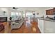 Spacious living room with hardwood floors, fireplace, ample natural light, and seamless transition to dining at 54053 Flycatchers Ct, Fort Mill, SC 29707