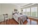 Comfortable bedroom featuring hardwood floors, natural light, and a tranquil ambiance at 54053 Flycatchers Ct, Fort Mill, SC 29707