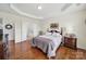 Spacious main bedroom with hardwood floors, tray ceilings, and an en-suite bathroom at 54053 Flycatchers Ct, Fort Mill, SC 29707