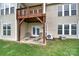 A covered back patio featuring outdoor seating and access to the upper level at 54053 Flycatchers Ct, Fort Mill, SC 29707