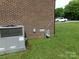 Exterior of a brick home featuring an air conditioner, gas meter, and green lawn at 556 Roundtree Cir, Chester, SC 29706