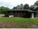 This brick home has a wooden deck, side entrance and lush landscaping at 556 Roundtree Cir, Chester, SC 29706