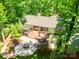Aerial view of backyard with a fire pit, patio, pergola, and lush landscaping creating a serene outdoor setting at 5719 Doncaster Dr, Charlotte, NC 28211