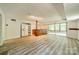 Finished basement boasts a bar, mini-fridge, recessed lighting, and sliding glass doors to the screened porch at 5719 Doncaster Dr, Charlotte, NC 28211