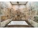 Close-up of a bathtub with stone tiles at 5719 Doncaster Dr, Charlotte, NC 28211