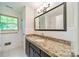 Bathroom featuring granite counters, black cabinets and white subway tile at 5719 Doncaster Dr, Charlotte, NC 28211