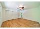 Bright bedroom with closet, hardwood floors and ceiling fan at 5719 Doncaster Dr, Charlotte, NC 28211