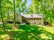 Charming single-Gathering home with a lush green lawn, mature trees, and classic architectural details at 5719 Doncaster Dr, Charlotte, NC 28211