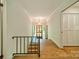 Open hallway with wood floors, white walls and views to the front door at 5719 Doncaster Dr, Charlotte, NC 28211