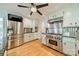 Modern kitchen features a stainless steel refrigerator, range, and white cabinets at 5719 Doncaster Dr, Charlotte, NC 28211