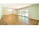 Bright, open living room with hardwood floors and a sliding glass door to the patio at 5719 Doncaster Dr, Charlotte, NC 28211