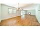 Spacious living room with hardwood floors, ample natural light, and modern chandelier at 5719 Doncaster Dr, Charlotte, NC 28211