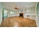 Bright living room features hardwood floors, built-in shelving, and a fireplace at 5719 Doncaster Dr, Charlotte, NC 28211