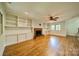 Spacious living room with natural light, hardwood floors, custom built-ins and a ceiling fan at 5719 Doncaster Dr, Charlotte, NC 28211