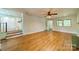 Inviting living room with hardwood floors, ceiling fan, and access to other rooms at 5719 Doncaster Dr, Charlotte, NC 28211
