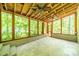 Spacious screened porch is built with travertine tile, brick accents and a wood beamed ceiling at 5719 Doncaster Dr, Charlotte, NC 28211