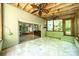 Relaxing screened porch with brick walls, two ceiling fans, and views of the private backyard at 5719 Doncaster Dr, Charlotte, NC 28211