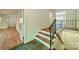 Unique staircase with hardwood steps, decorative iron railing and stone floor detail at 5719 Doncaster Dr, Charlotte, NC 28211