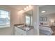 Bathroom featuring granite counters, double sinks, large mirror, and view into an adjacent bedroom at 574 Altamonte Dr, Clover, SC 29710